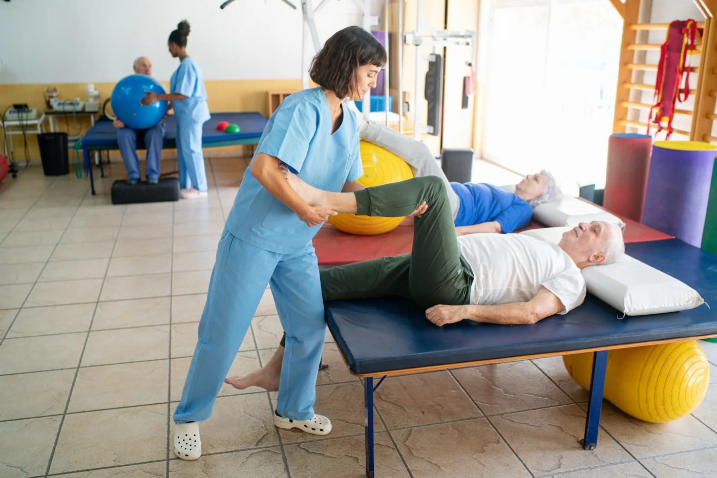 A physical therapist treating a patient in a clinic